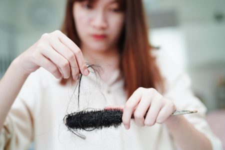 asian-woman-have-problem-with-long-hair-loss-attach-comb-brush